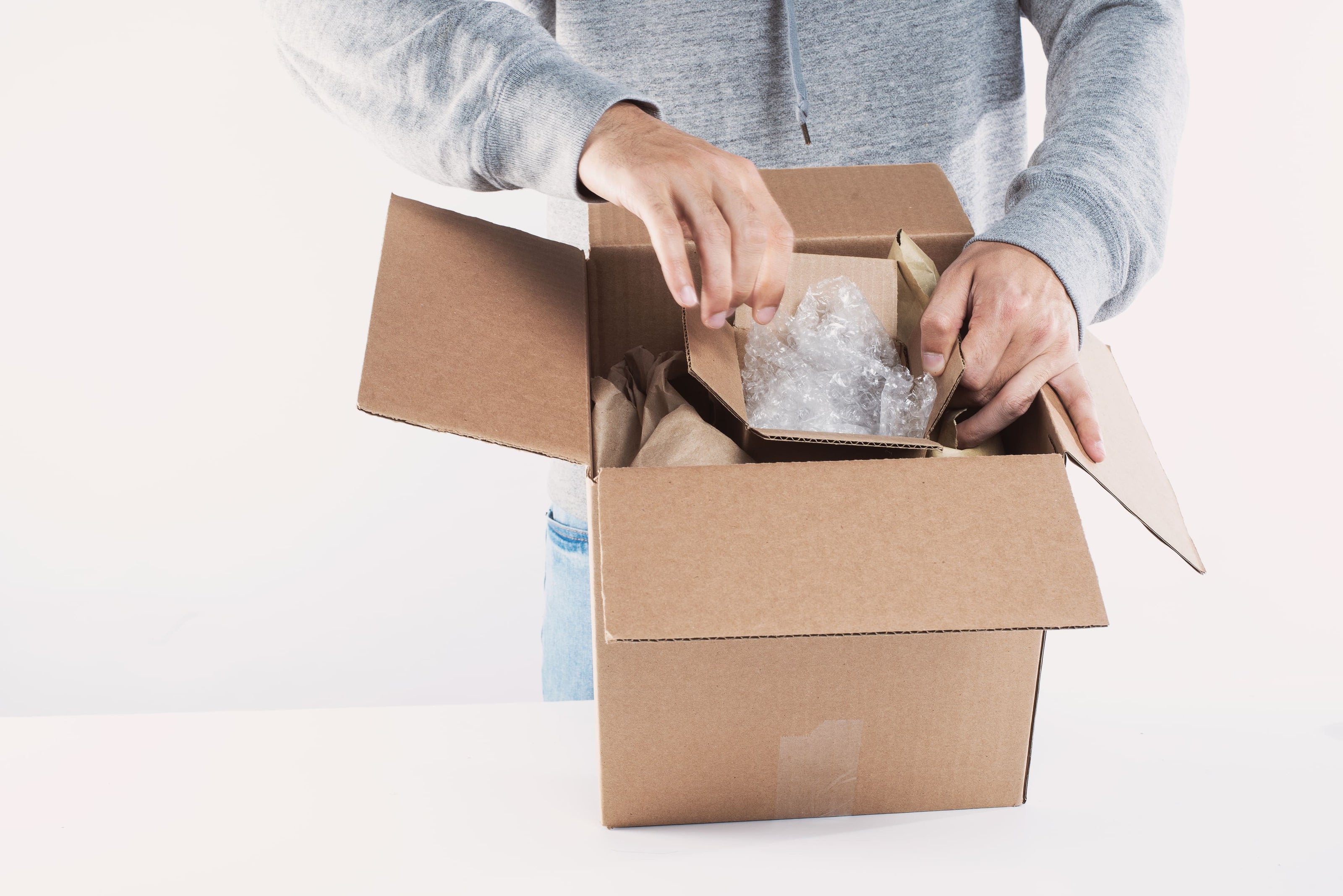 young-man-fills-a-box-with-packing - La Fabrique à Malices